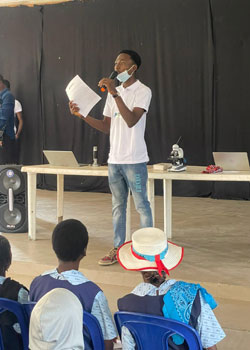 Volunteer presenting to group of children