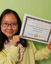 Photo of Rhianne Lee holding a certificate.