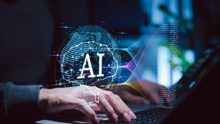 Artificial intelligence concept. A developer using laptop with AI digital globe interface ©iStock/Supatman