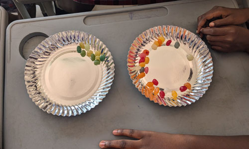 Two plates of jelly beans on a desk