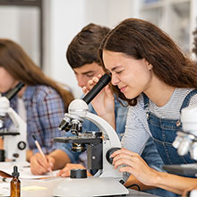 Student looking through a microscope