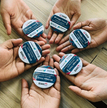 A-group-of-hands-holding-badges-200x300.gif 1