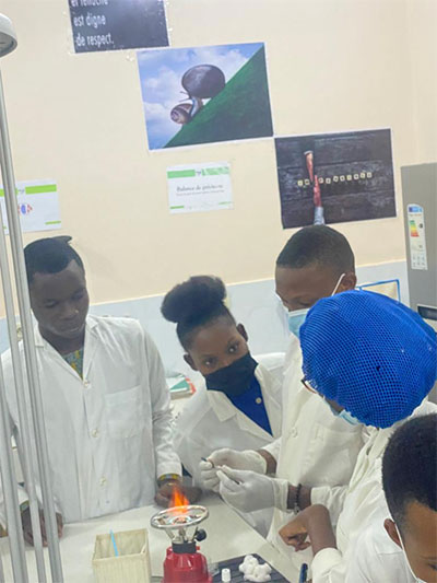Scientists in a lab, around a flame 