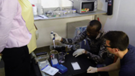 Three man doing tests with a pipette