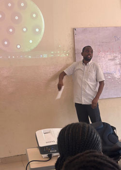 Society Champion, Yinka Somorin presenting at a school