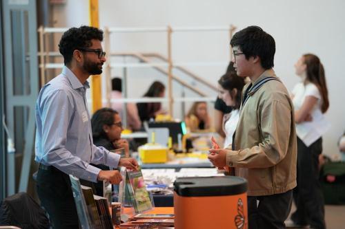 Delegate talking to exhibitor at LINE event