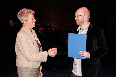 A person being awarded a certificate.
