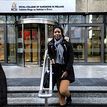Dr Sylviane Yoba standing on steps outside a building.