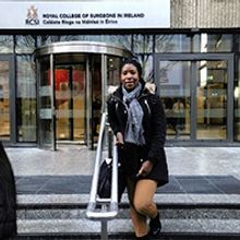 Dr Sylviane Yoba standing on steps outside a building.