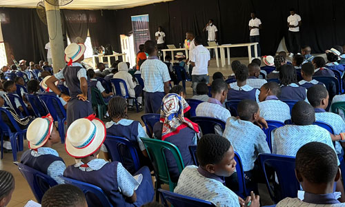 Volunteers presenting to group of children