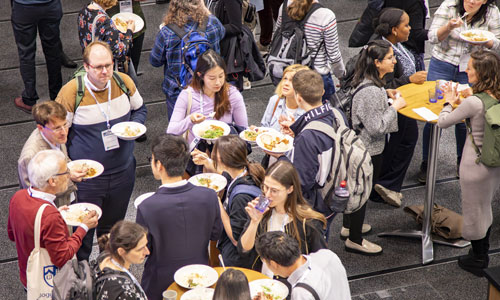 Group of people talking and eating at a conference