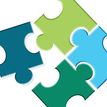 Illustration of four multi-coloured puzzle pieces interlocking.