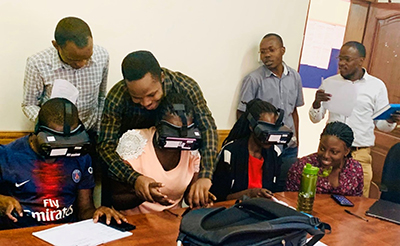 Multiple people using a virtual reality headset.