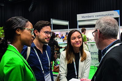 A group of people talking at a conference.