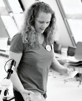 Photo of Ruth Maclaren with a microscope.
