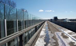 Acrylic sound barriers are seen lining a busy motorway in Denmark