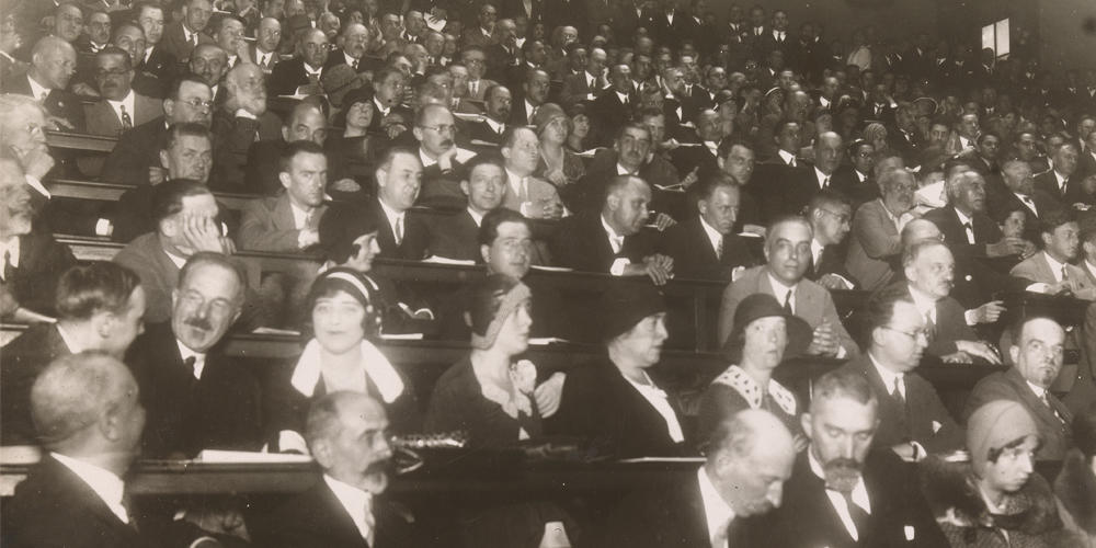 Close-up of delegates awaiting the next session at the Second International Congress of Microbiology in 1936, London, UK.