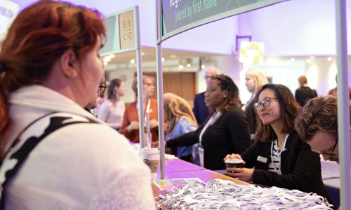 Person collecting their badge from the registration desk at Annual Conference 