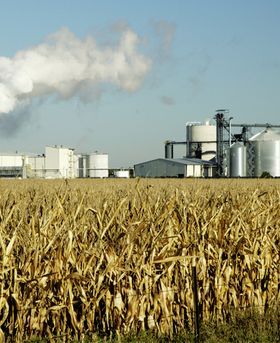 Photograph of a powerplant in a open field.