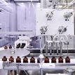 Production line machine filling dark coloured bottles