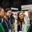 A group of people talking at a conference.