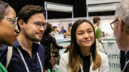 A group of people talking at a conference.