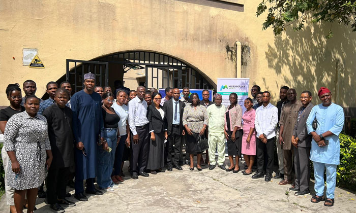 Group of event attendees posing outside venue