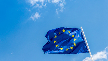 EU flag blowing in the wind on a sunny day.
