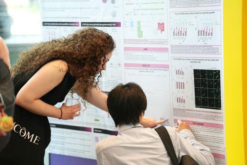 Delegates looking a scientific poster at LINE event