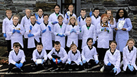 Teacher with students in rows posing for the picture